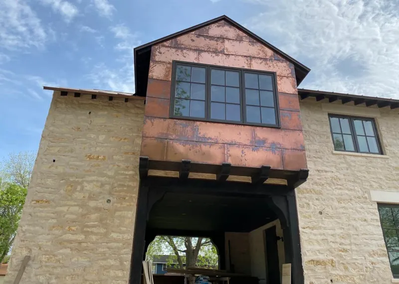 Copper metal panel facade on a stone building for Skylight Installation in Shaler